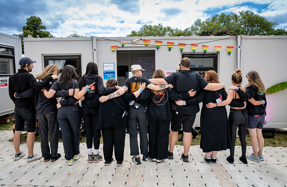 Backstage crew holding one another